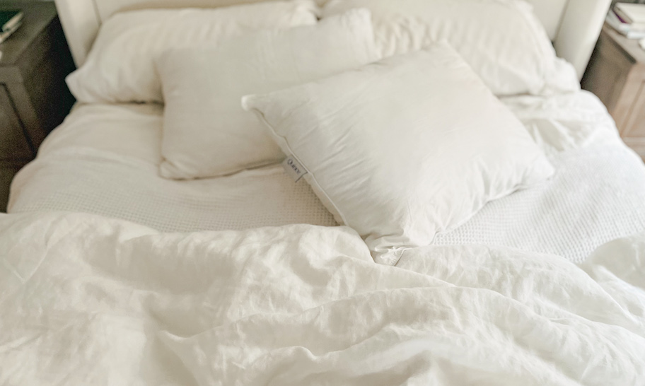 white bedding and pillows on bed