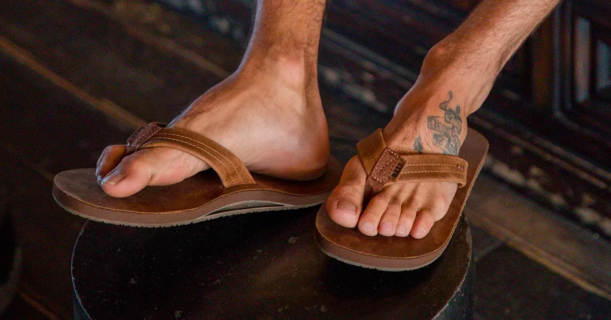 man wearing brown reef sandals
