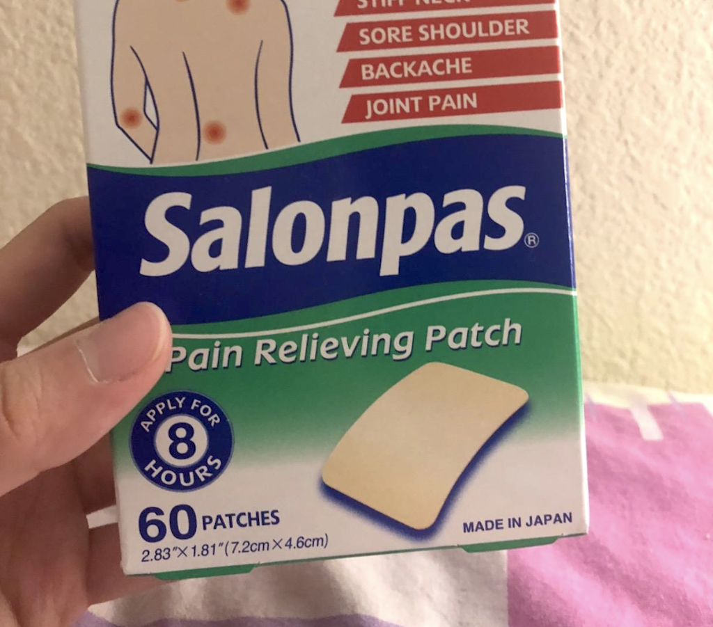holding Salonpas patch