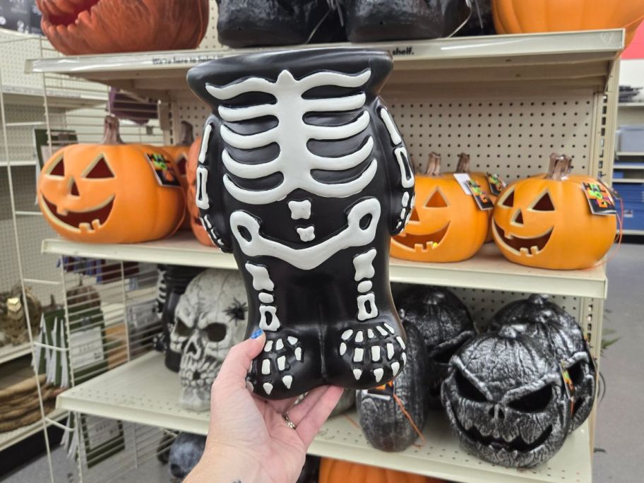 10" Skeleton Blow Mold Pumpkin Stand in hand in store