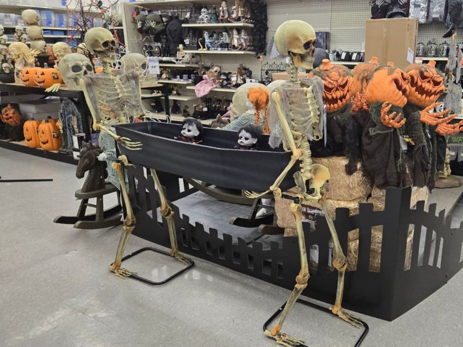 skeletons carrying coffin in store