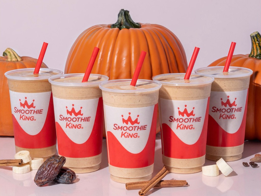 smoothie king pumpkin smoothies in front of pumpkins