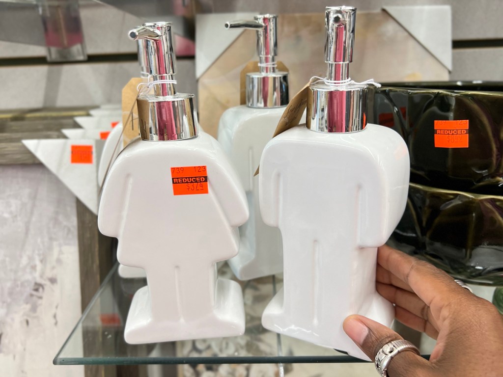 hand reaching for girl and boy soap dispensers