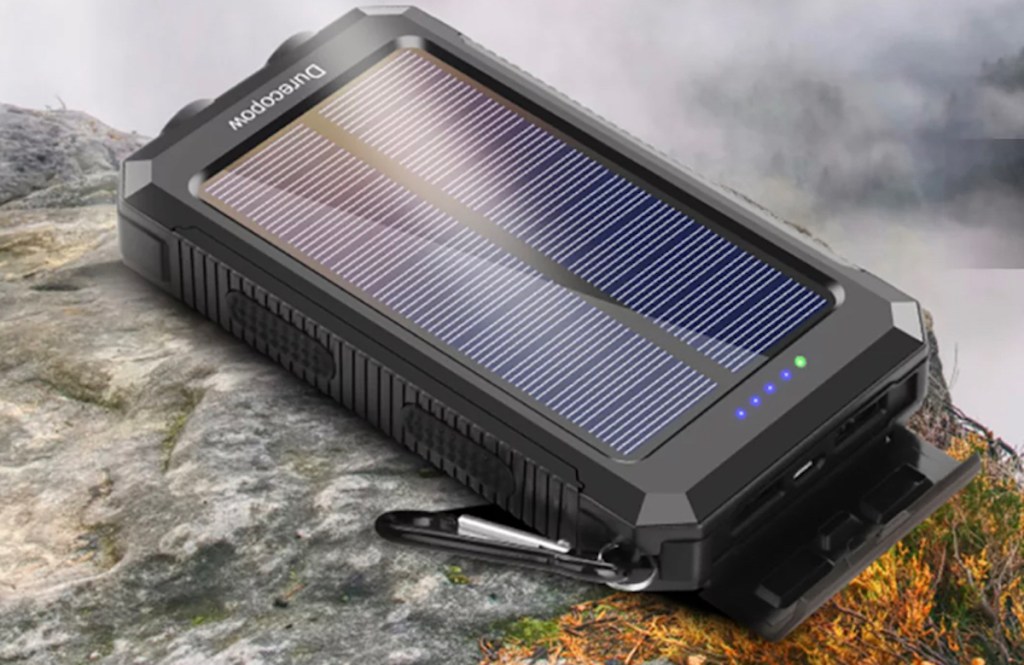 solar battery pack laying on top of rock