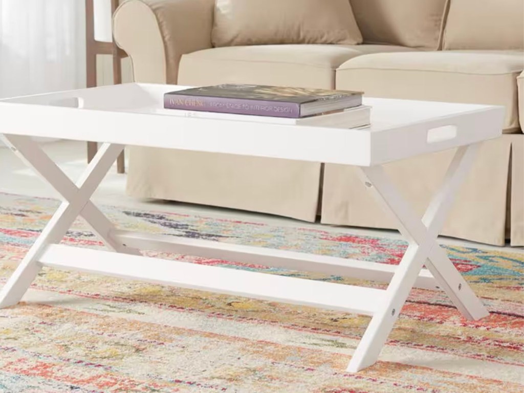 white coffee table with books on top