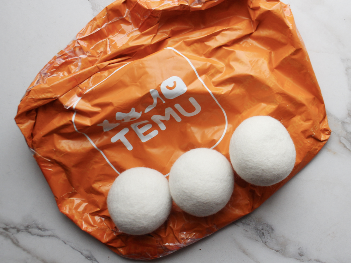 three dryer balls sitting on temu packaging