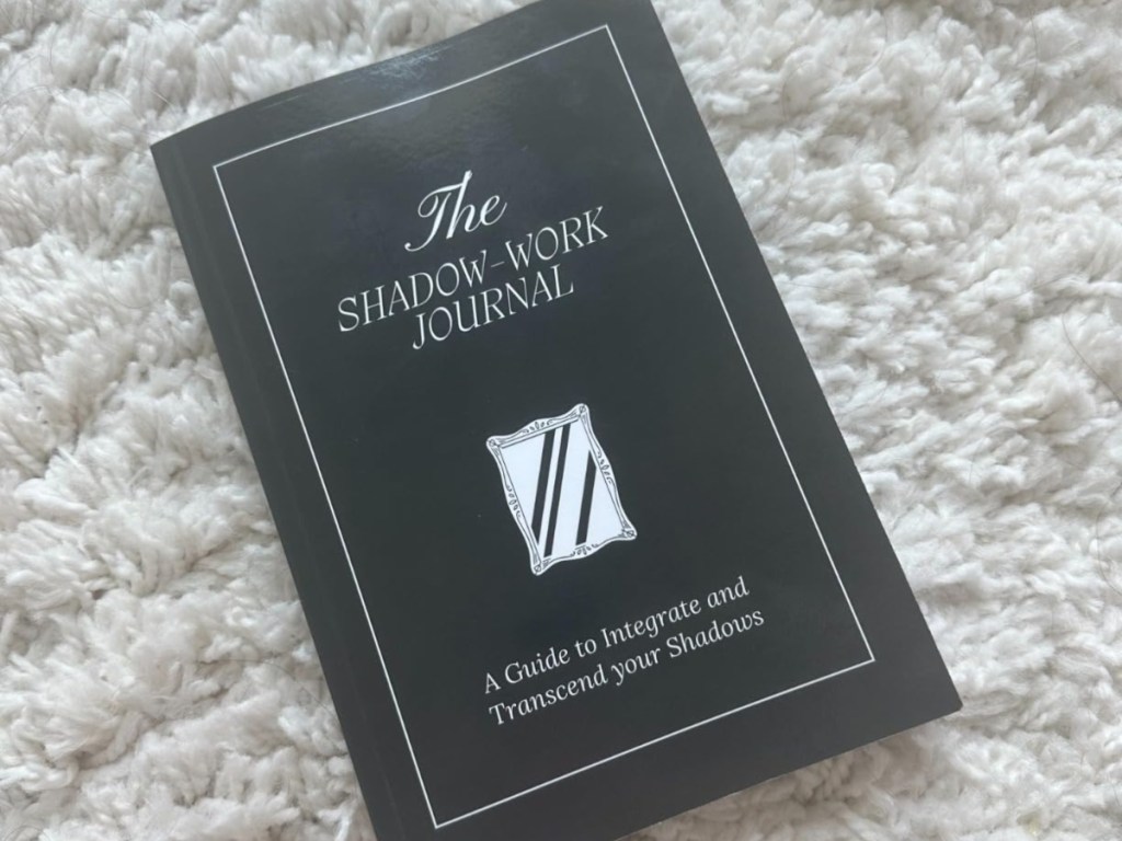 The Shadow Work Journal on a white blanket