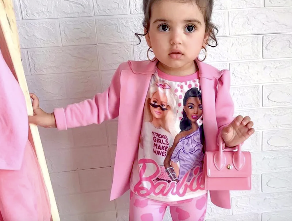 toddler wearing pink Barbie pajamas and jacket 