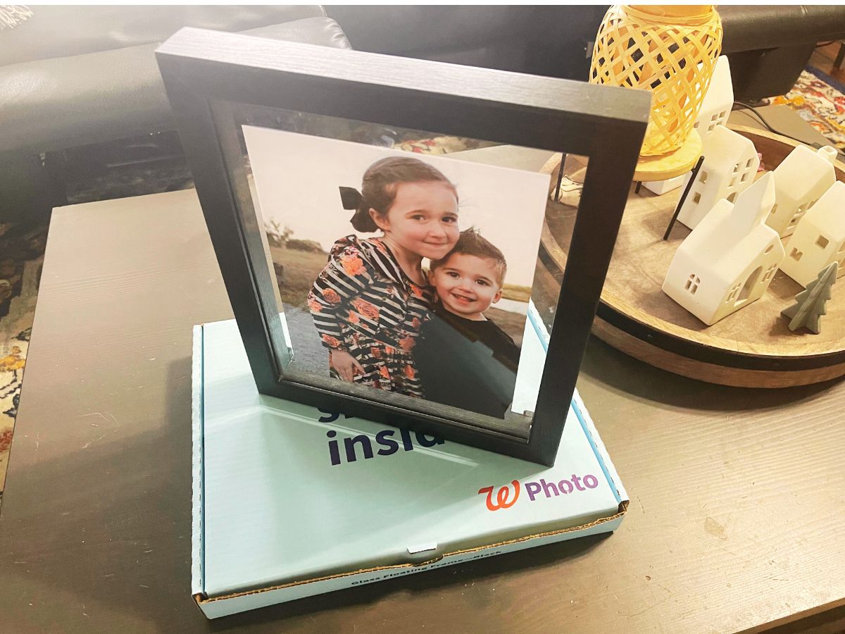 picture inside floating frame sitting on walgreens photo box on end table