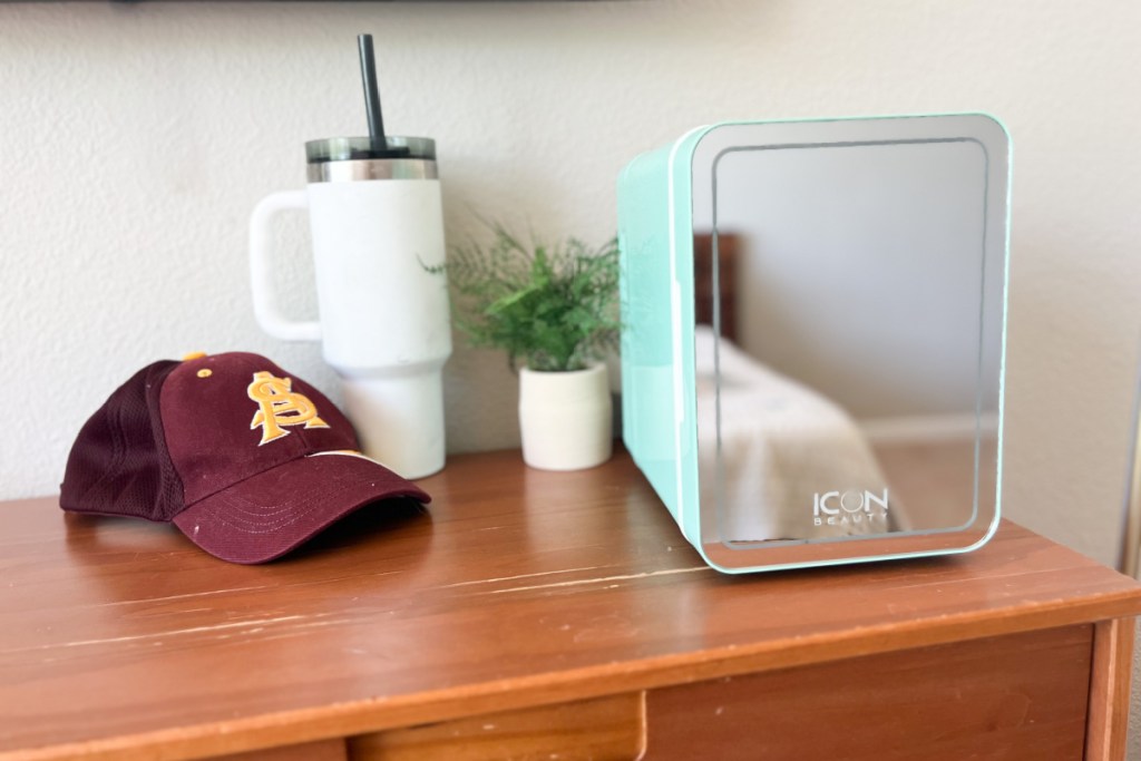 college baseball cap next to trending tumbler and mini fridge