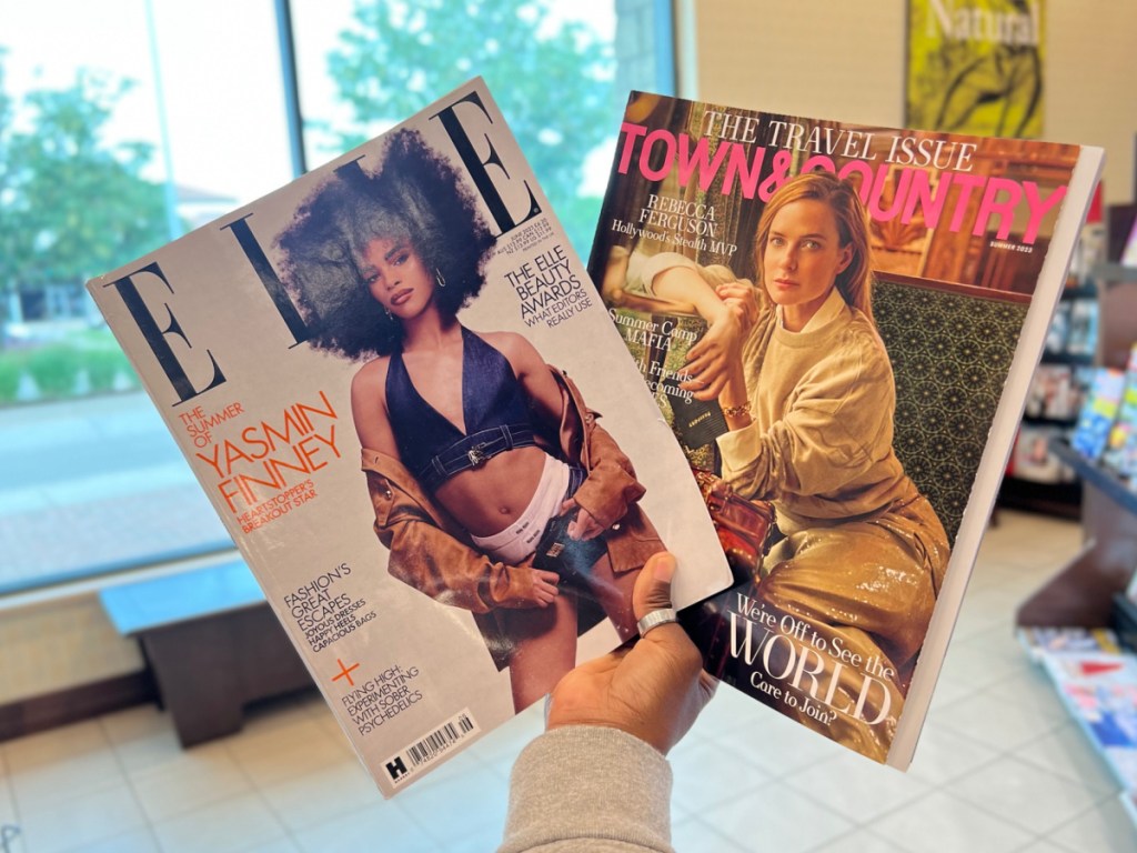 woman holding two magazines at the store