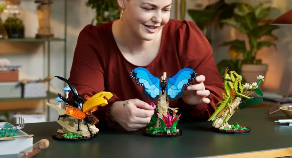 woman playing with new lego insect collection