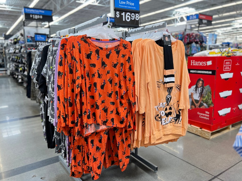 womens orange halloween pajamas hanging on rack in walmart store 