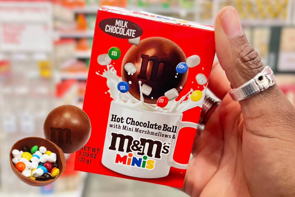 Hand holding M&M Minis Hot Chocolate Bomb in Target store
