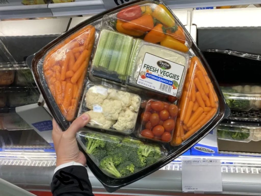 hand holding a large veggie tray platter at Sam's Club