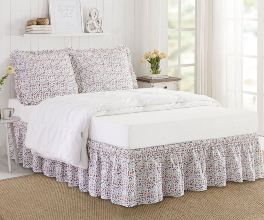 a set of pillow shams and bedskirt on a bed.
