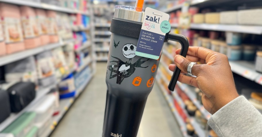 hand holding a large Jack Skellington stainless steel mug with handle in a store aisle