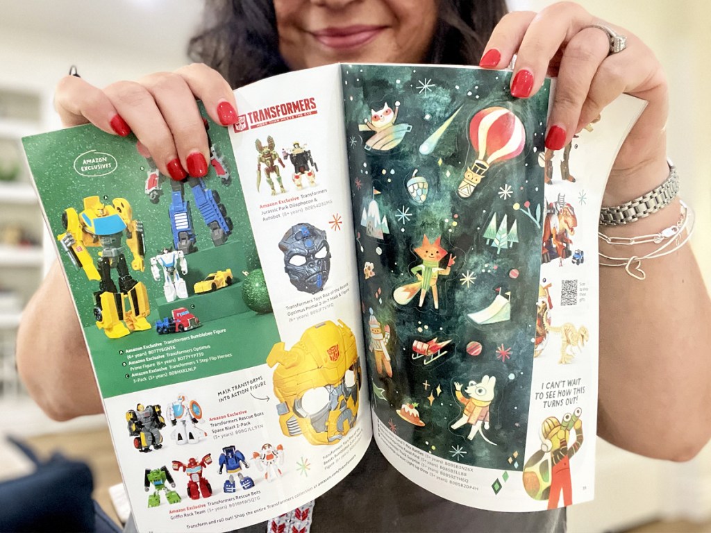 holding up opened Amazon Holiday Toy Catalog Book