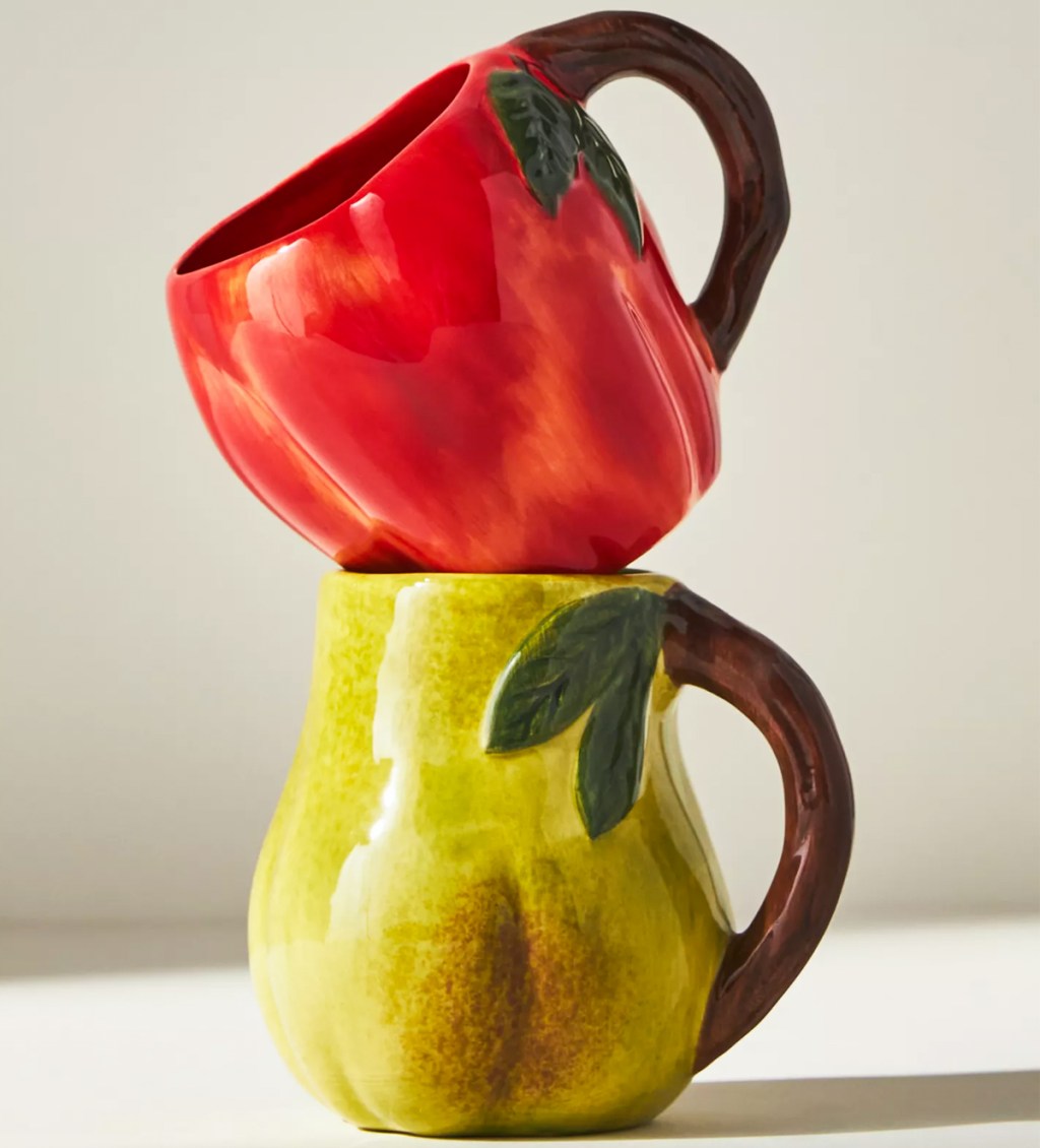 apple and pear shaped mugs stacked on each other