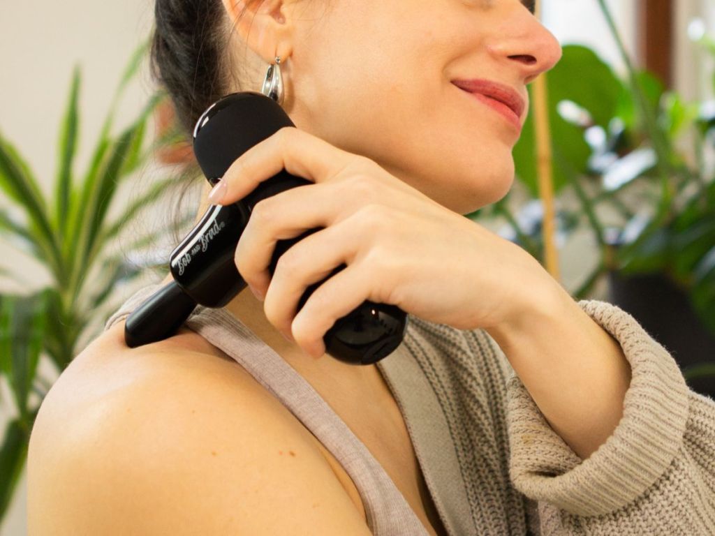 Woman using a BOB AND BRAD Q2 Mini Pocket-Sized Deep Tissue, Portable Percussion Muscle Massager Gun on her shoulder