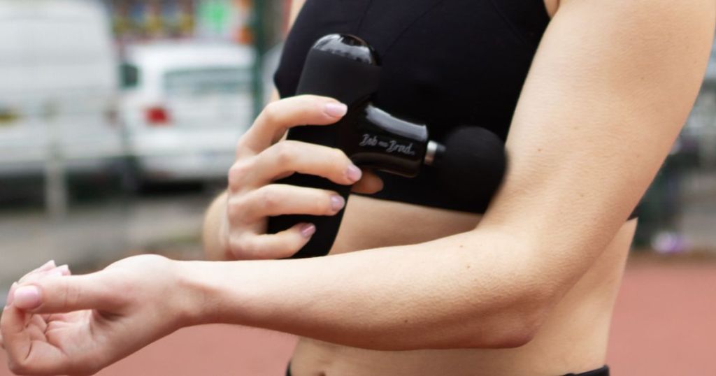 Woman using the BOB AND BRAD Q2 Mini Pocket-Sized Deep Tissue, Portable Percussion Muscle Massager Gun on her arm