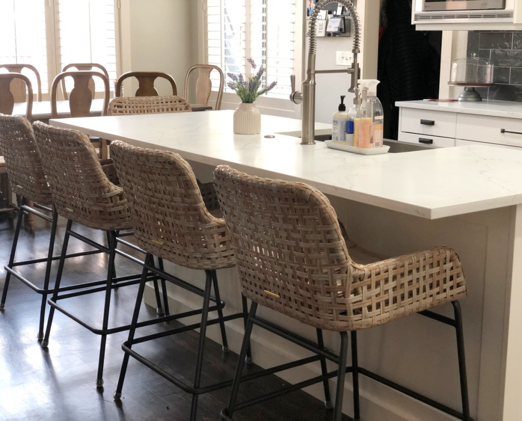 A kitchen counter with woven bar stools from Ballard Designs