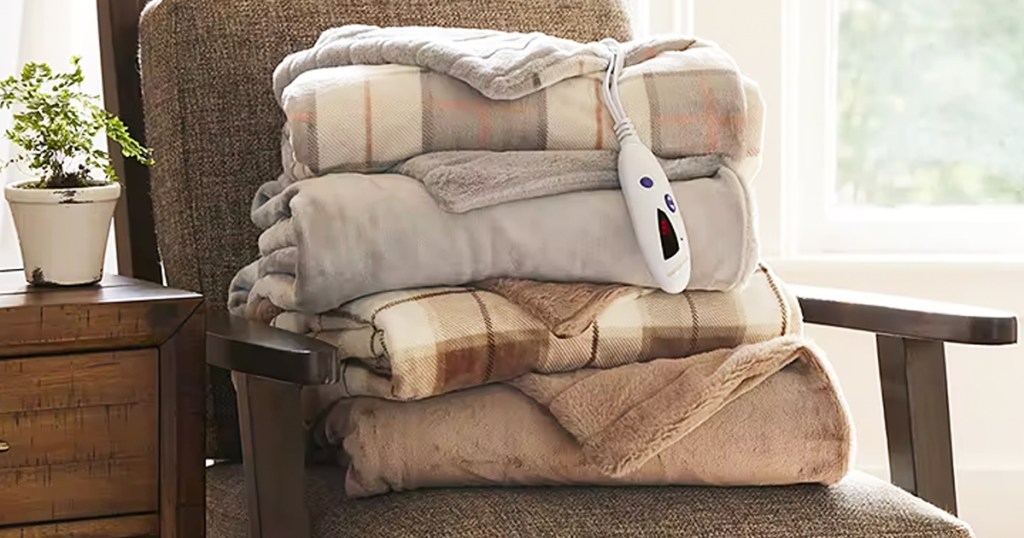 stack of folded heating blankets on a chair