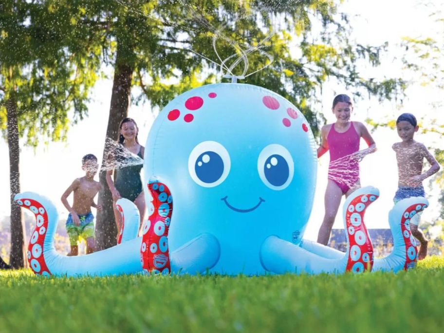 kids playing with a huge inflatable octopus sprinkler