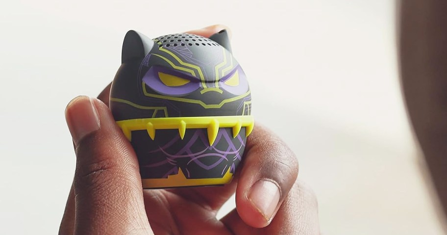 hand holding a mini Black Panther bluetooth speaker