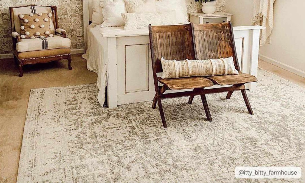 cream rug in neutral bedroom with wood floor