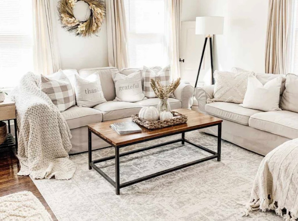 styled neutral living room with beige sectional couch and cream rug