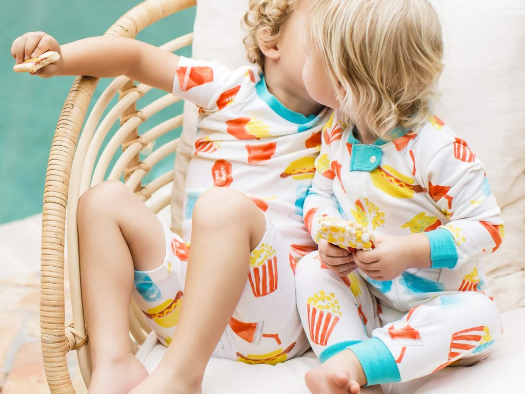 two kids in chair wearing matching pajamas