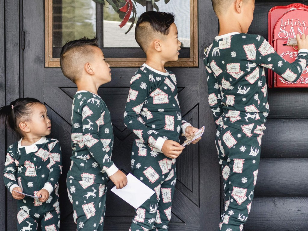 kids standing in line to mail letters to santa all wearing matching pjs