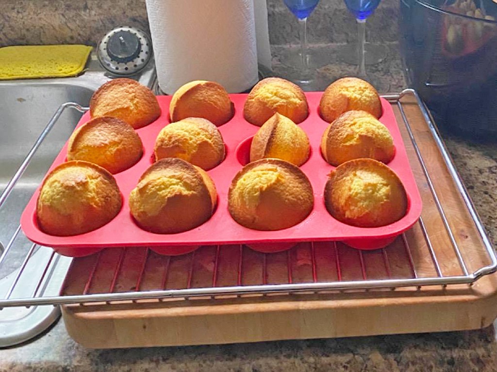 red silicone muffin pan with muffins on a kitchen counter