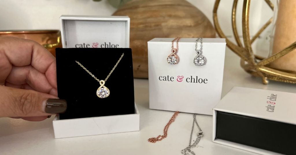  cate and chloe pendant necklaces and boxes on table