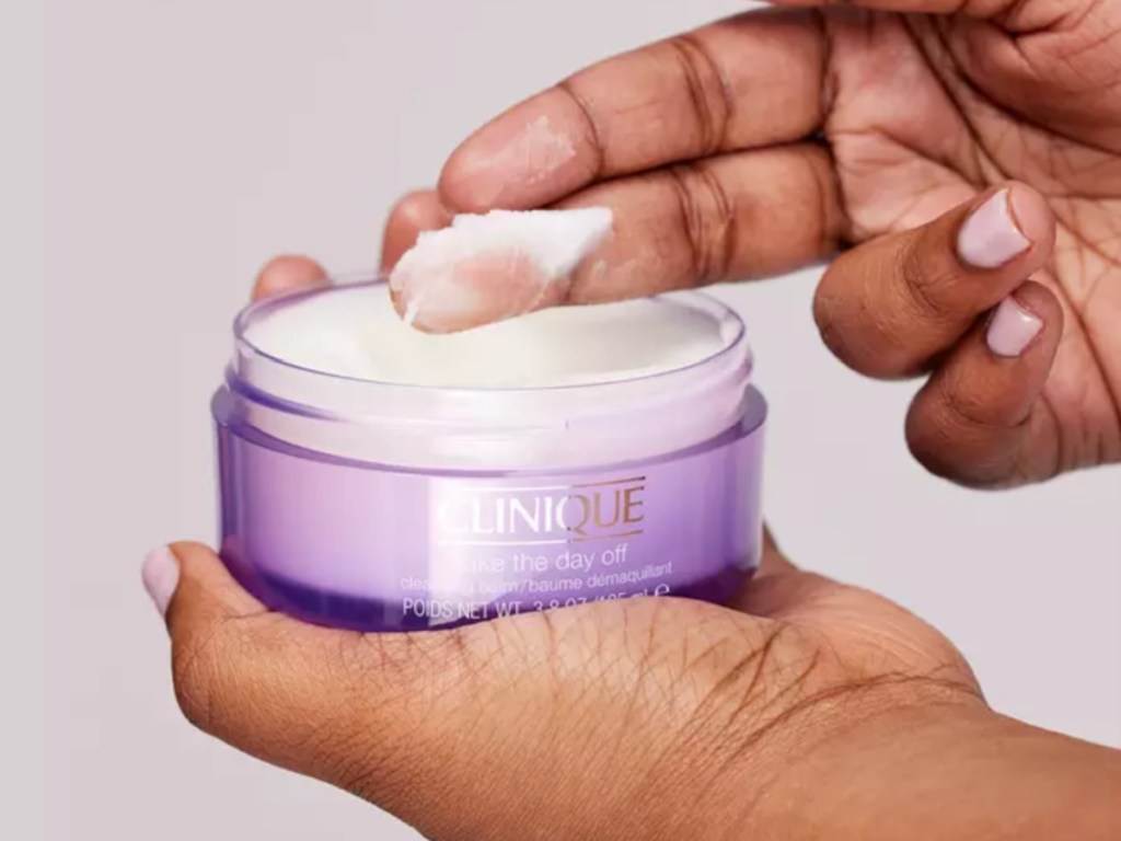 Clinique makeup removing balm with person holding it