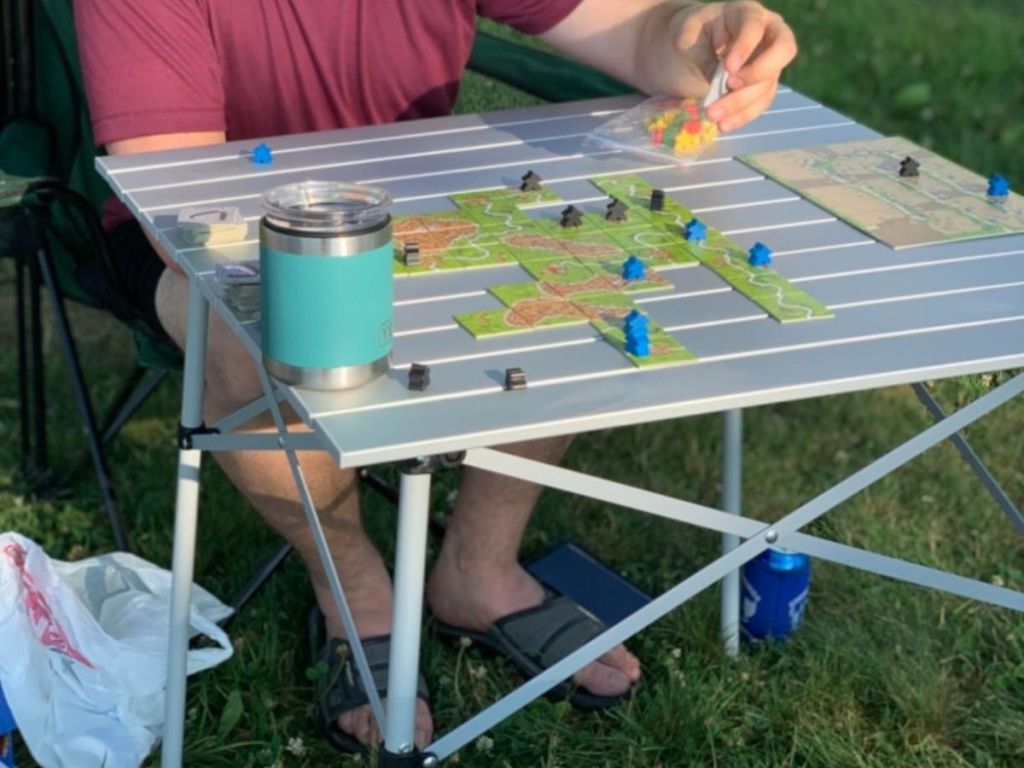 A man playing a board game on Coleman aluminum table