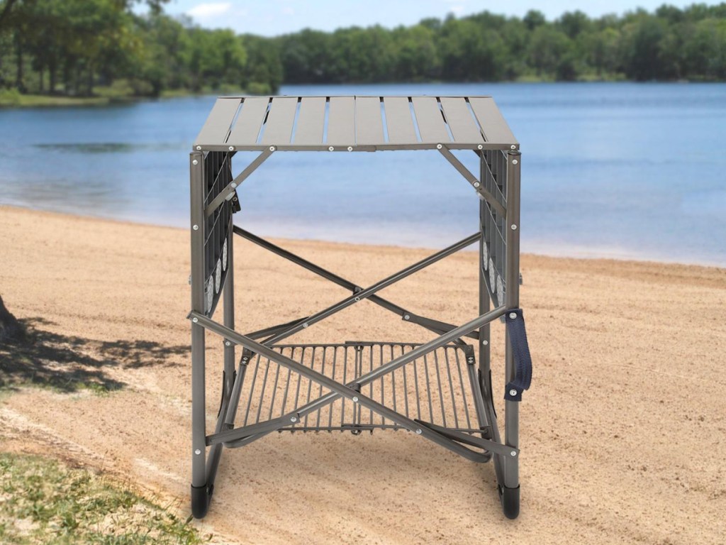 Cuisinart Take Along Grill Stand with grill displayed at the beach folded up