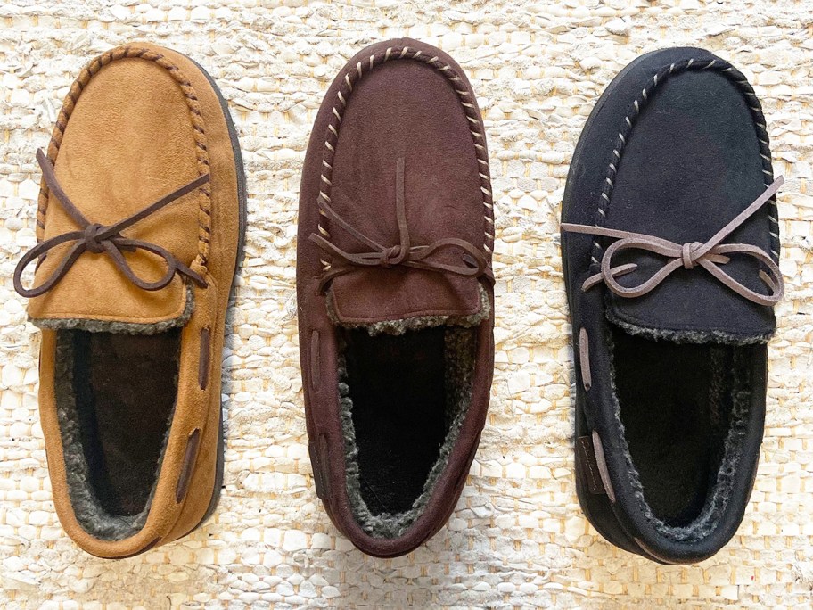 three pairs of moccasin slippers on white rug