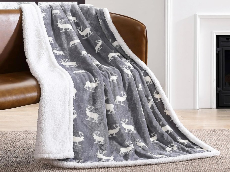 grey elk print throw blanket draped over chair