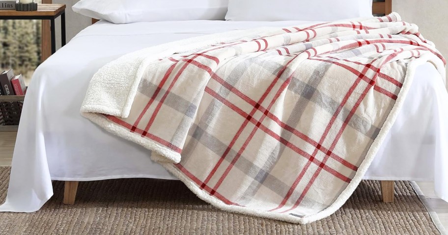 white and red throw blanket draped over bed