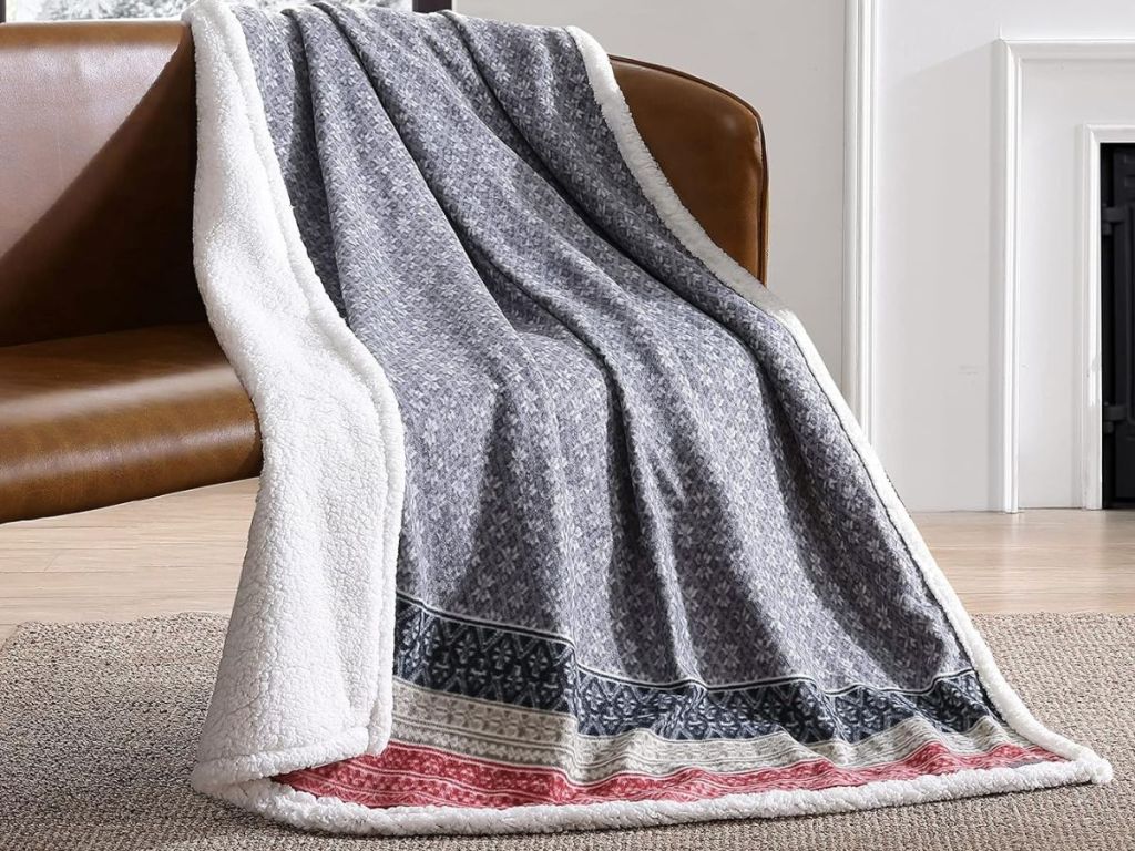 An Eddie Bauer Throw blanket draped on a couch