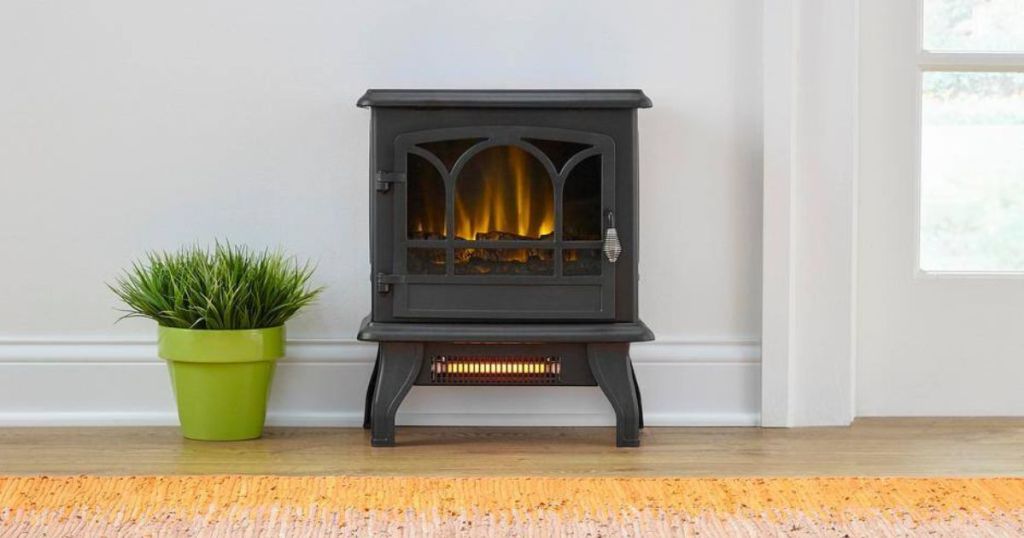 electric stove with flame by plant in room