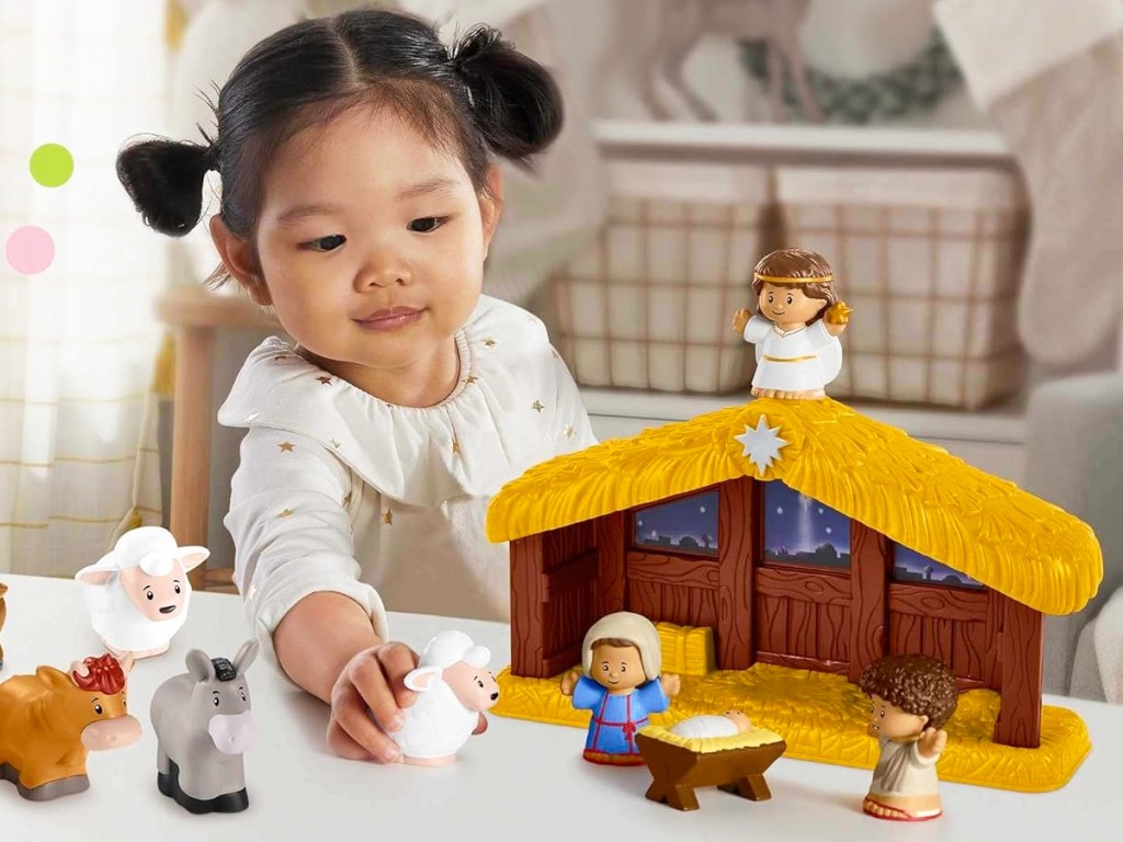 girl playing with Fisher-Price Little People Nativity Playset