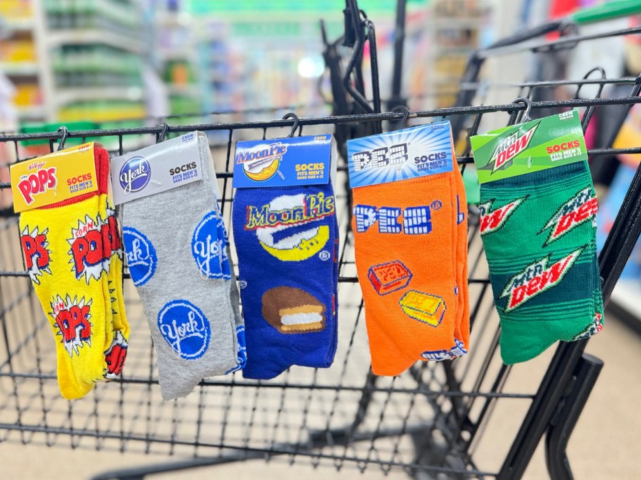 Five novelty socks displayed on dollar tree shopping cart