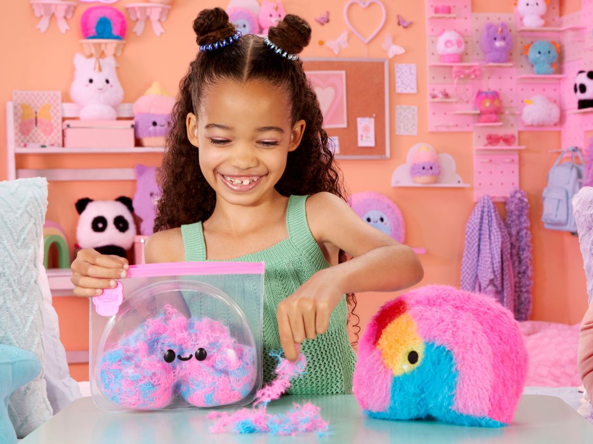Little girl revealing a Fluffie Stuffiez rainbow plush