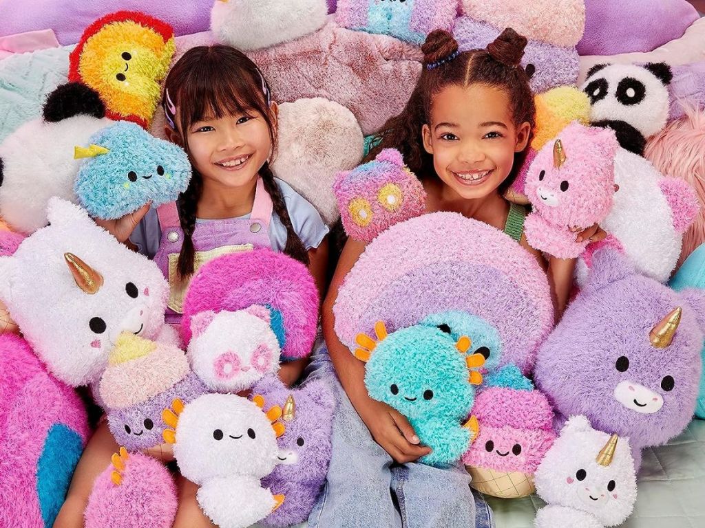2 little girls a pile of Fluffie Stuffiez Toys