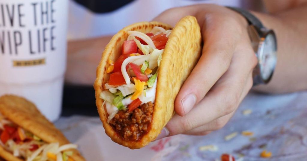 Hand holding a Chalupa Supreme from taco Bell