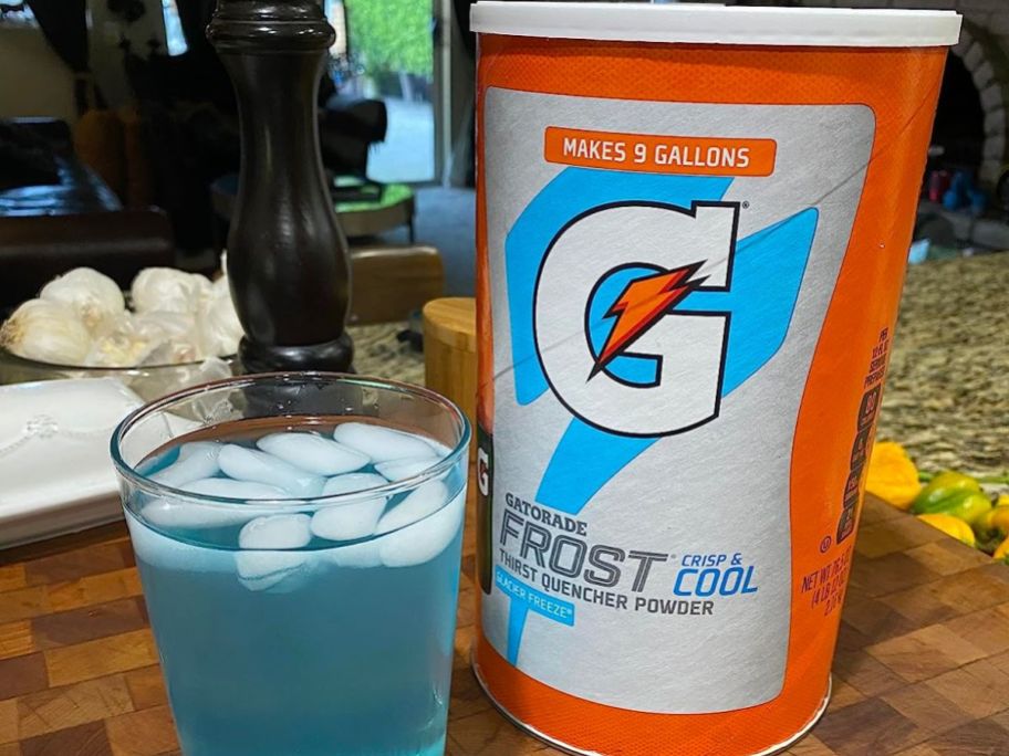 Gatorade Frost Powder canister and a glass filled with blue Gatorade