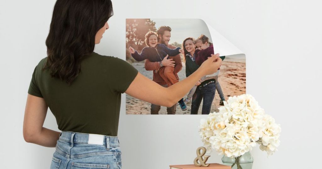 woman moving a 16x20 Repositionable Poster from CVS